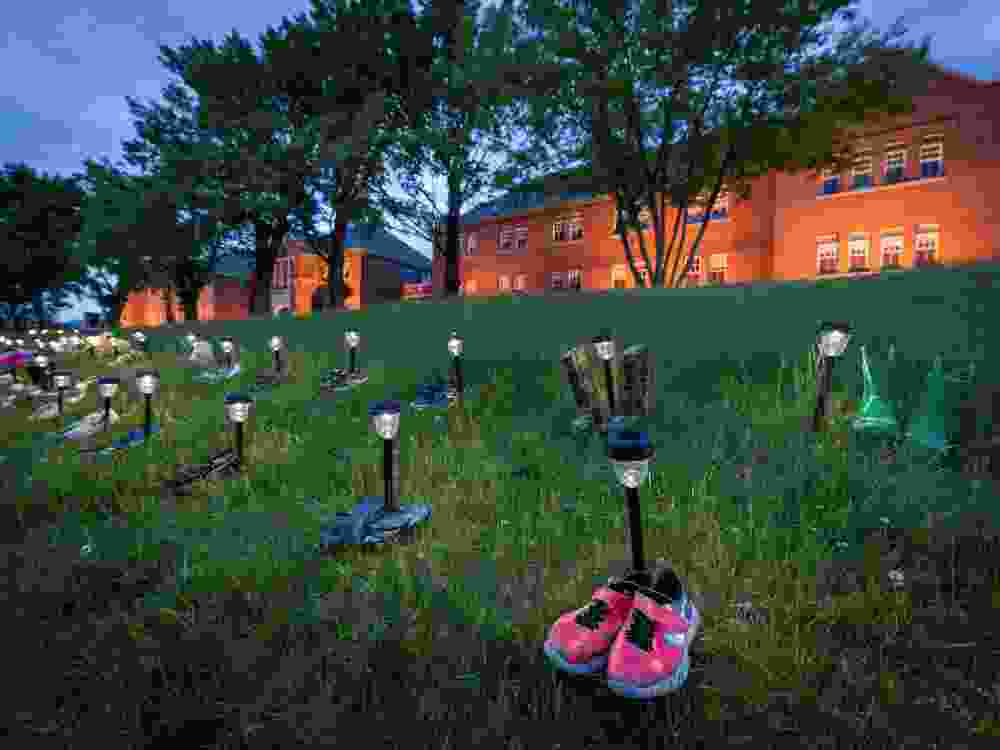 Pairs of children’s shoes and toys are seen at memorial in front of the former Kamloops Indian Residential School after the remains of 215 children were found at the site last week, in Kamloops, British Columbia.